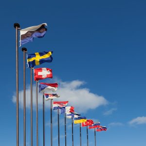 National flags of different countries on a background of blue sky